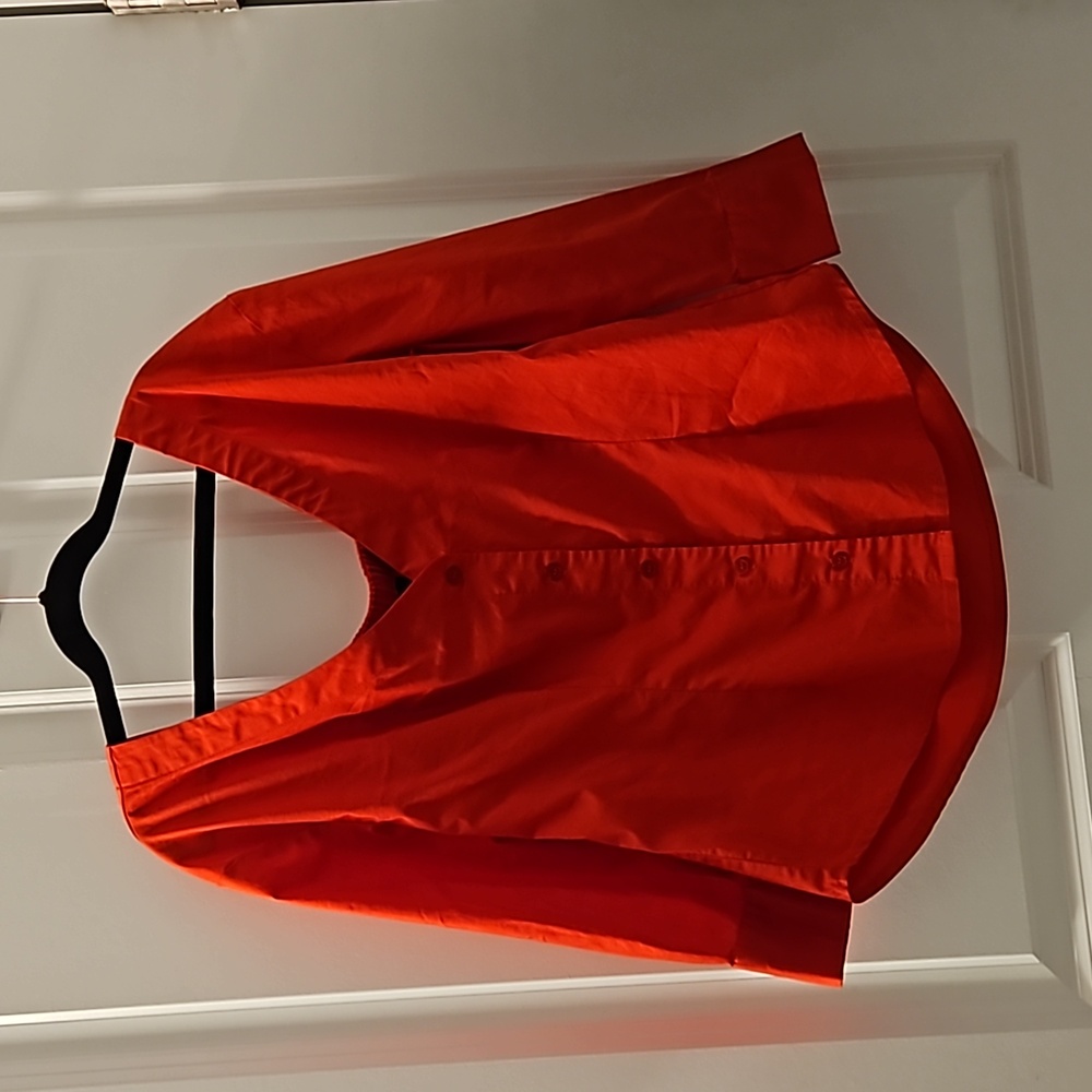 A red-orange offsoulder button down